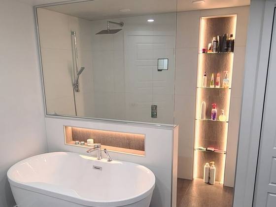 Salle de bain avec bain autoportant et niche de bois